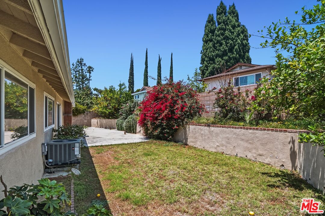 19131 Tulsa Street Porter Ranch, CA 91326 - Photo 39 of 43 a view of a house with a flower garden