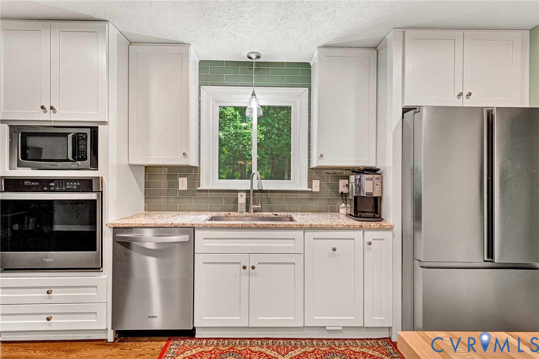 3841 Strawhill Road Richmond, VA 23231 - Photo 8 of 56 White shaker-style cabinetry with stainless steel