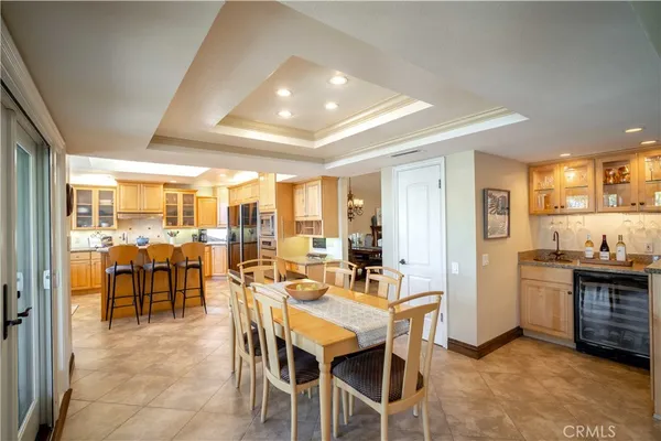 a kitchen with stainless steel appliances granite countertop a sink refrigerator and cabinets