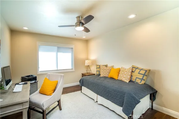 a bedroom with a bed a lamp and a window