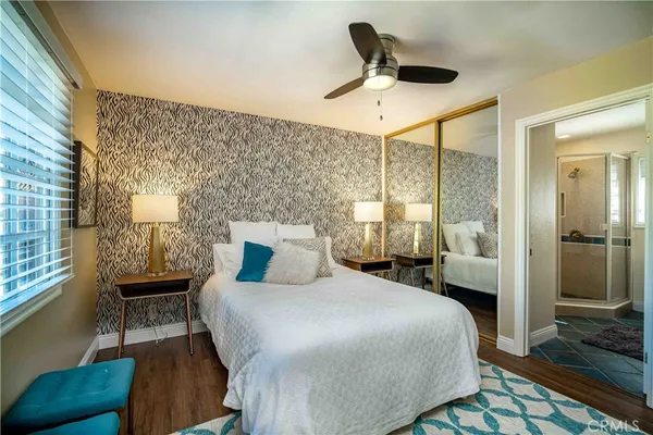 a bedroom with a bed a chair and a window
