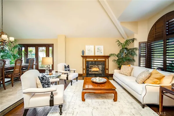 a living room with furniture fireplace and a large window