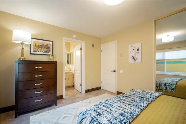 a bedroom with a bed and a dresser