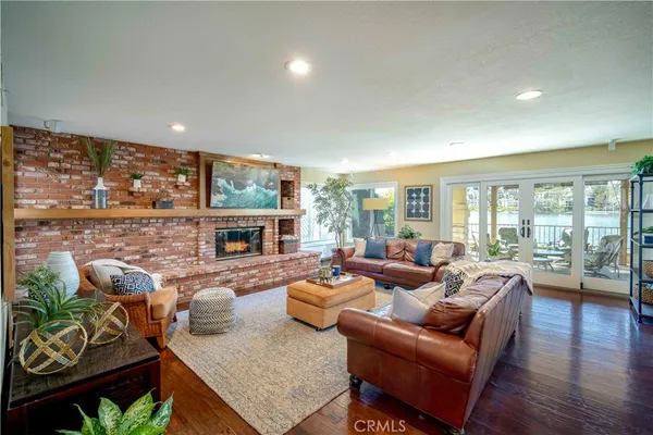 a living room with fireplace furniture and a large window