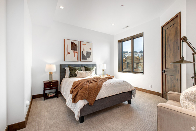 1282 Chimney Rock Road, Unit 344 Heber City, UT 84032 - Photo 44 of 55 Bedroom featuring a large window, recessed lighting, and a wood-finish door