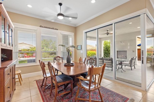 a living room with furniture a flat screen tv and a large window