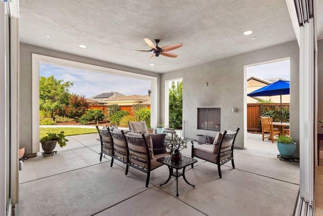 a spacious bedroom with a large bed a table and chair