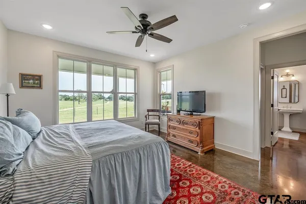 a bedroom with a balcony a bed and a television