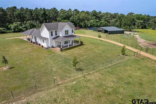 a view of a house with a yard and a swimming pool