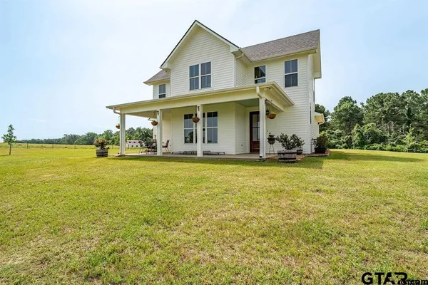 a front view of house with yard and outdoor seating