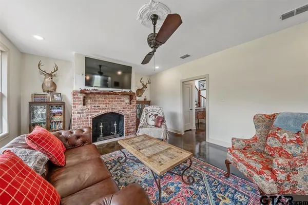 a living room with furniture and a fireplace