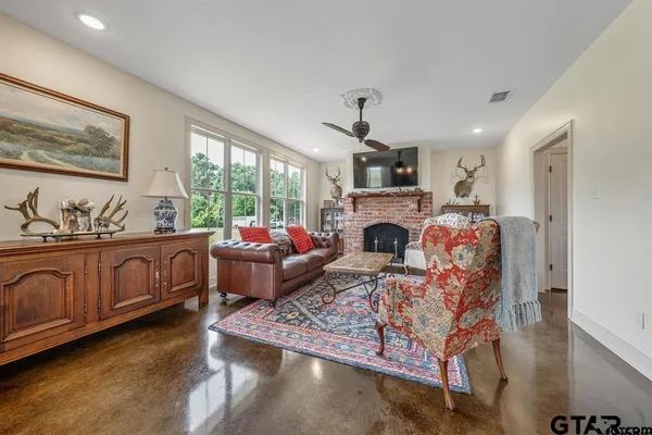 a living room with furniture fireplace and window