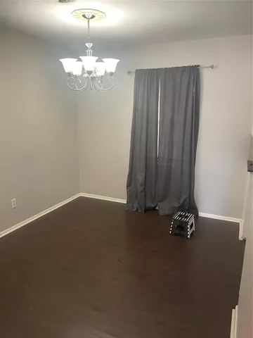 a view of a room with a chandelier fan