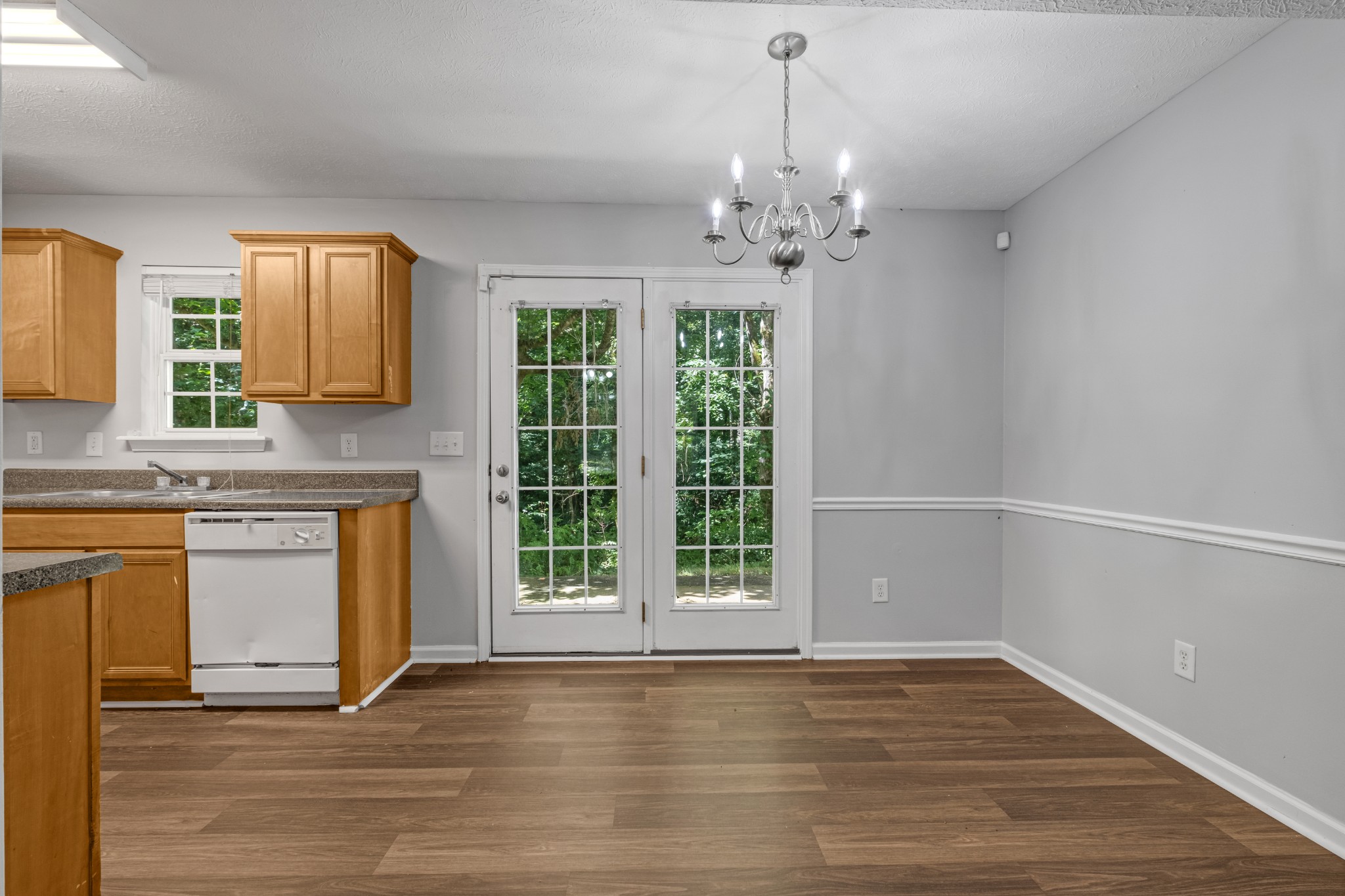 809 Dover Glen Drive Antioch, TN 37013 - Photo 7 of 23 a view of an empty room with a window and wooden floor