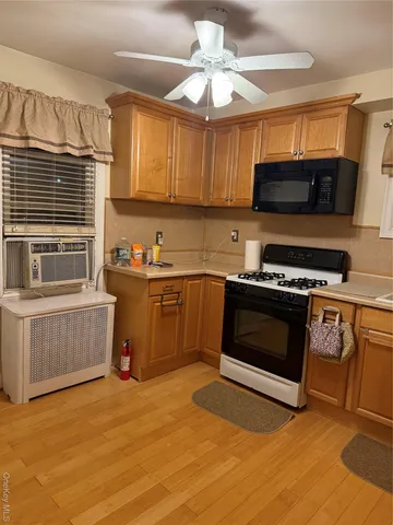 a kitchen with stainless steel appliances a stove a sink and a microwave
