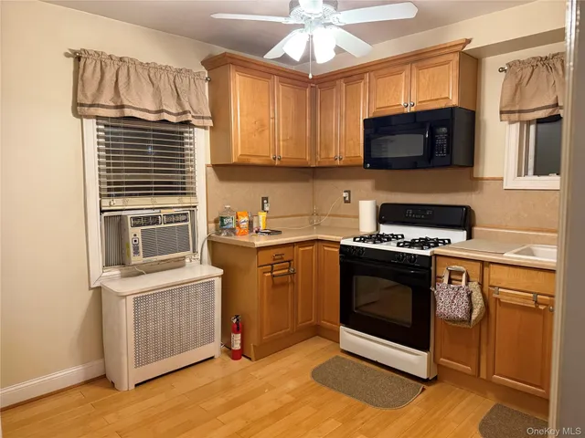 a kitchen with stainless steel appliances granite countertop a stove a microwave and a refrigerator