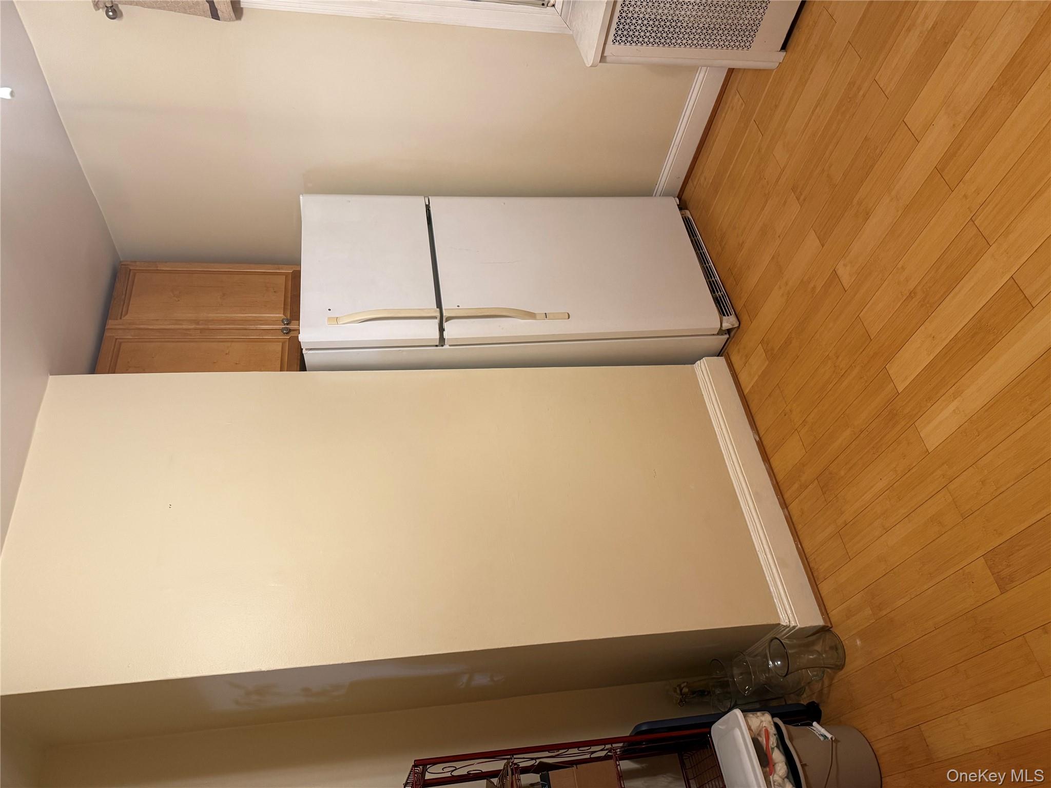 85 Bucknell Road Valley Stream, NY 11580 - Photo 5 of 15 a view of a refrigerator in kitchen and hardwood floor