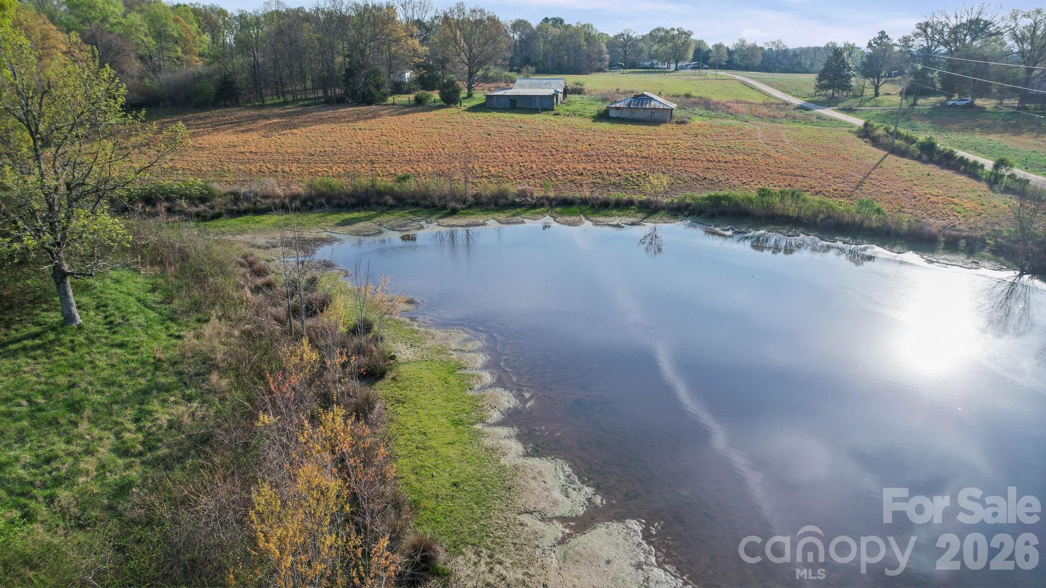 0 Rape Road Monroe, NC 28112 - Photo 14 of 21 a view of a lake with houses in the background