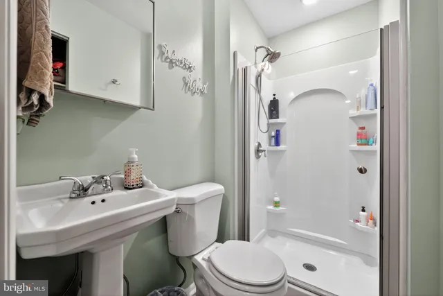 a bathroom with a sink mirror vanity and toilet