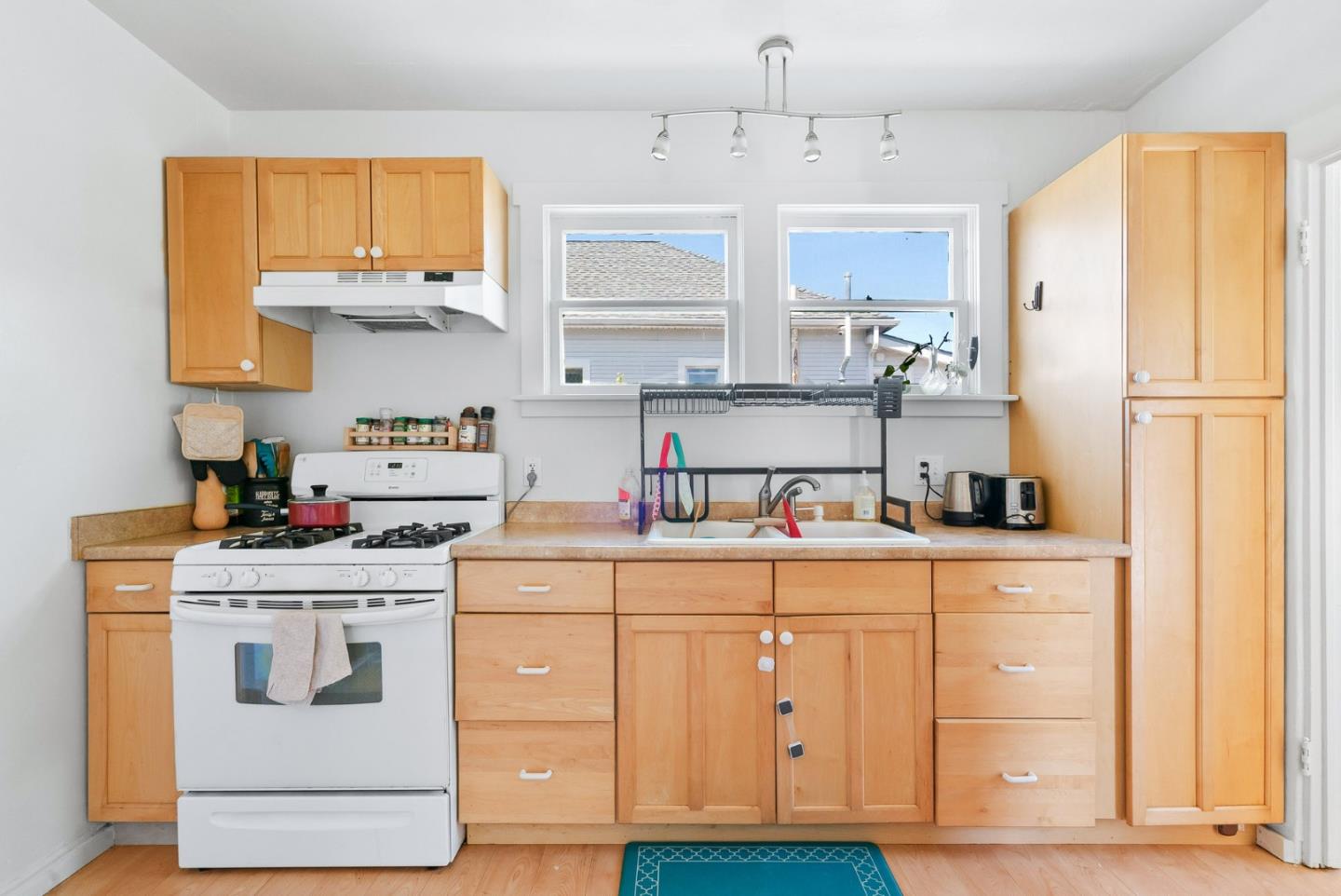 620 Sumner Street Santa Cruz, CA 95062 - Photo 37 of 45 a kitchen with white cabinets and white appliances