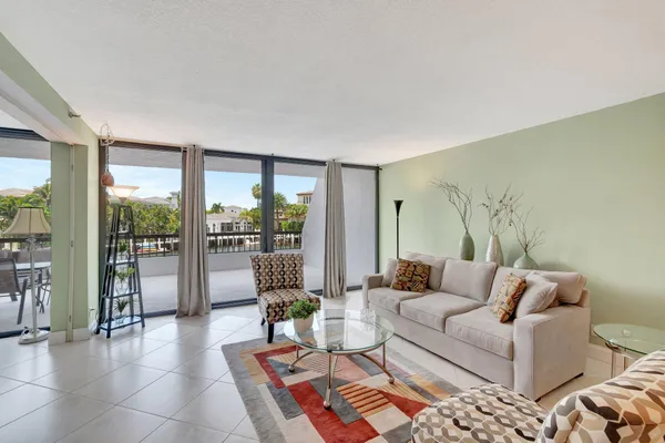 a living room with furniture and a floor to ceiling window