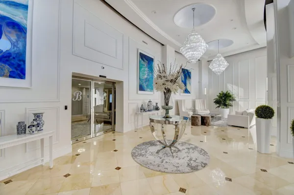 a dining room with furniture and a chandelier