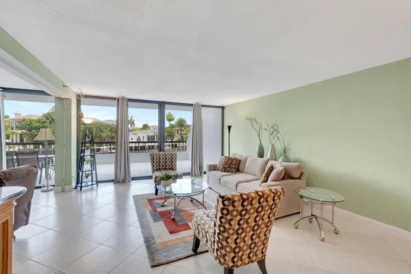 a living room with furniture and a floor to ceiling window