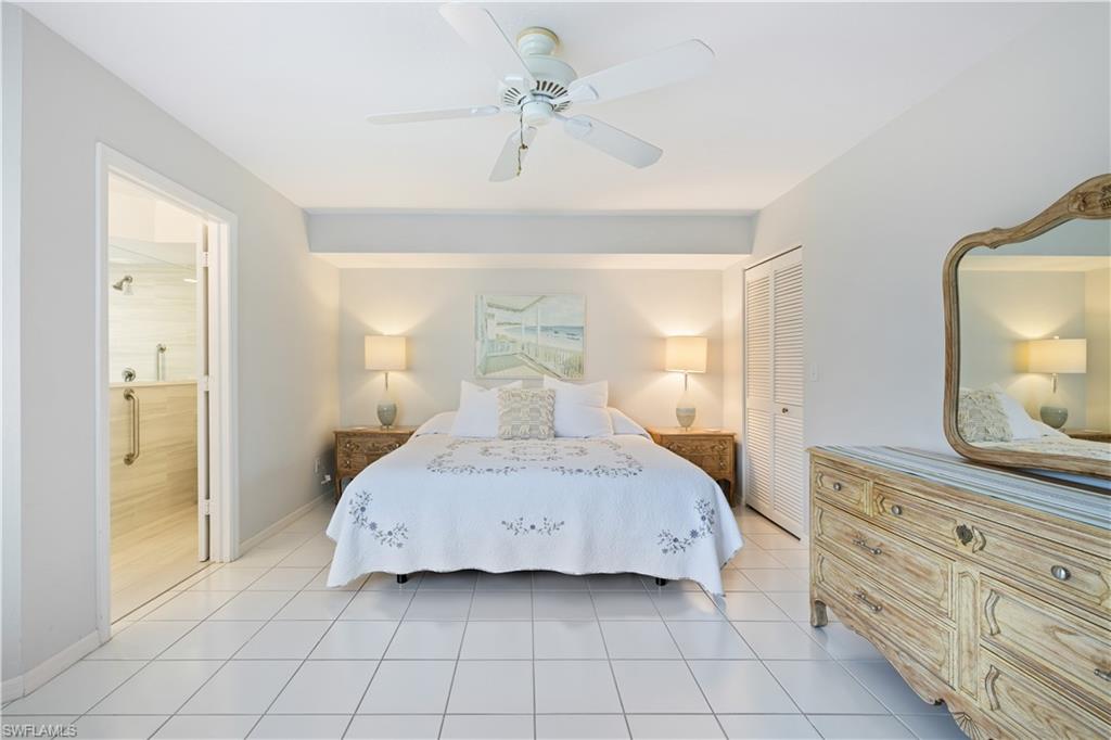 565 Beachwalk Circle, Unit T102 Naples, FL 34108 - Photo 11 of 33 a bedroom with a bed and window