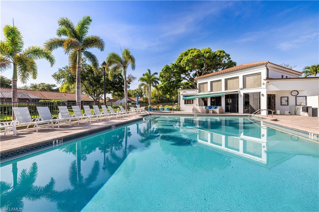565 Beachwalk Circle, Unit T102 Naples, FL 34108 - Photo 21 of 33 a view of a house with pool and sitting area