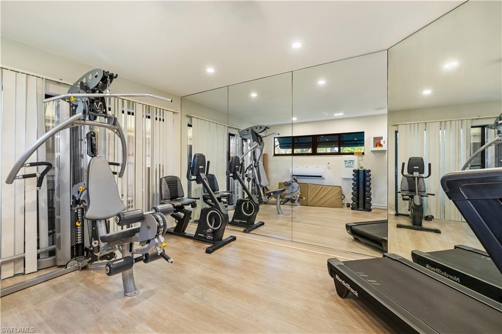 565 Beachwalk Circle, Unit T102 Naples, FL 34108 - Photo 27 of 33 a view of a room with gym equipment