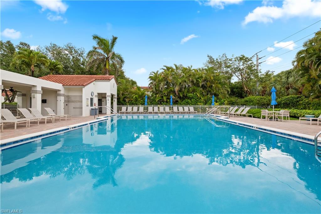 565 Beachwalk Circle, Unit T102 Naples, FL 34108 - Photo 29 of 33 a view of a swimming pool with a patio