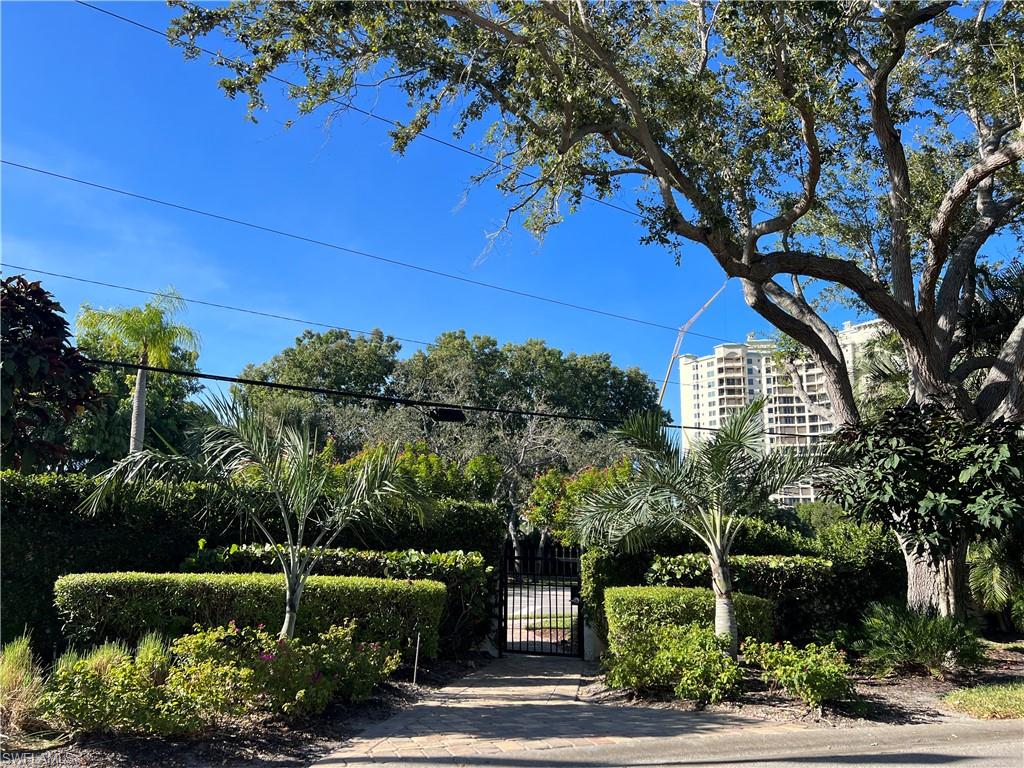 565 Beachwalk Circle, Unit T102 Naples, FL 34108 - Photo 31 of 33 a view of an outdoor space and a yard