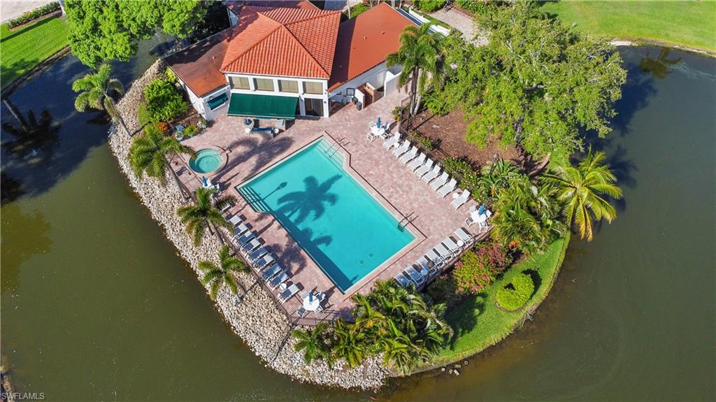 565 Beachwalk Circle, Unit T102 Naples, FL 34108 - Photo 33 of 33 an aerial view of a house with a garden and swimming pool