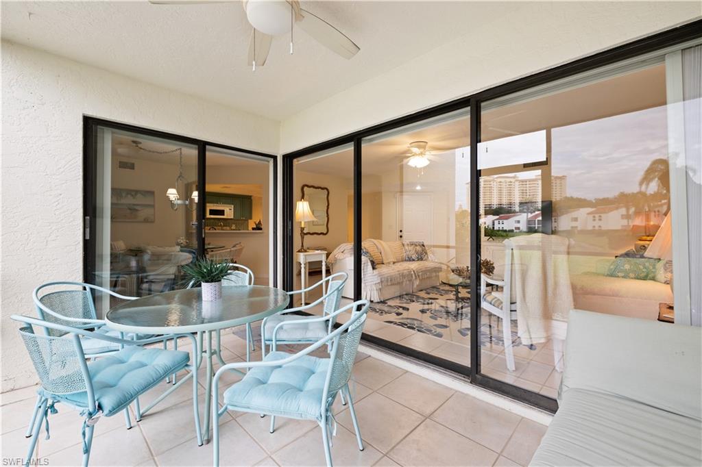 565 Beachwalk Circle, Unit T102 Naples, FL 34108 - Photo 4 of 33 a very nice looking room with a large window and furniture