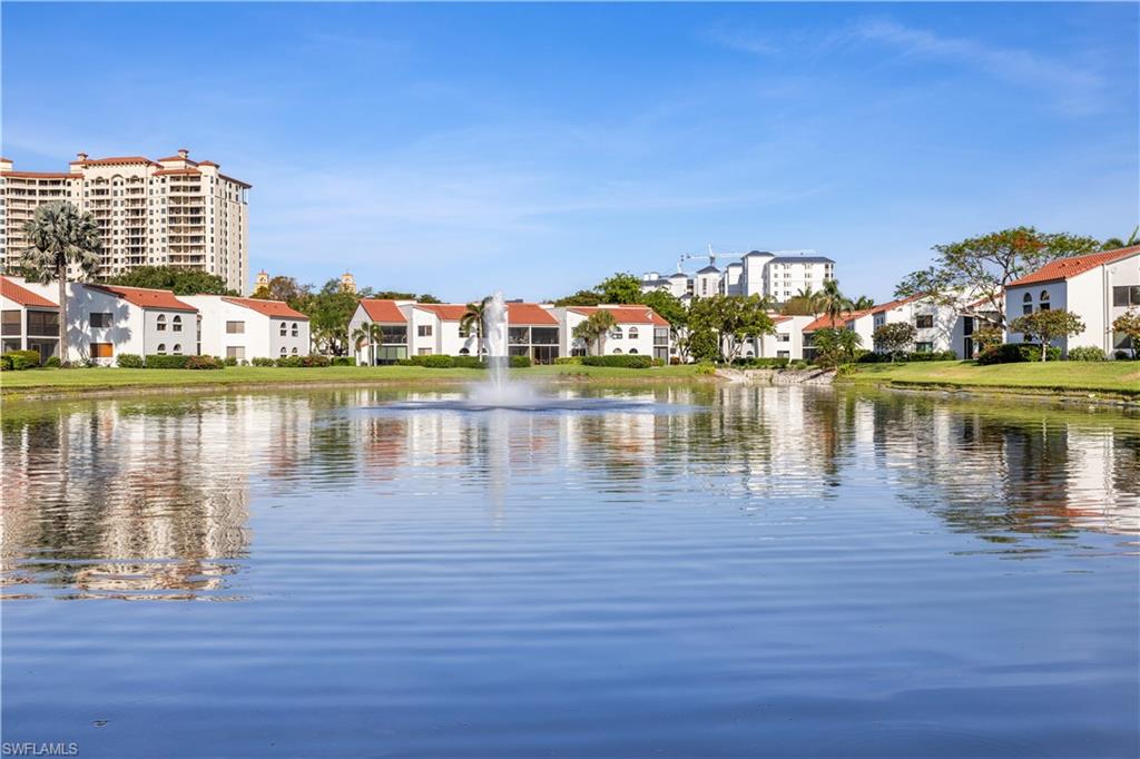 565 Beachwalk Circle, Unit T102 Naples, FL 34108 - Photo 6 of 33 a view of a lake with houses