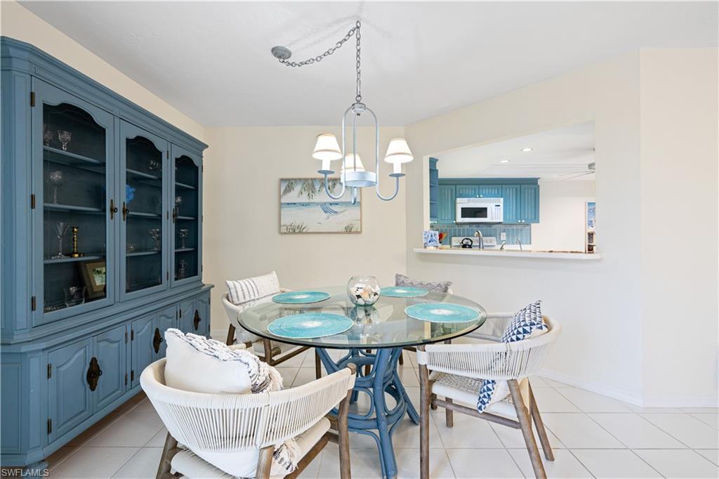 565 Beachwalk Circle, Unit T102 Naples, FL 34108 - Photo 7 of 33 a dining room with furniture and window