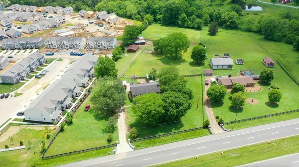 an aerial view of a residential houses with yard
