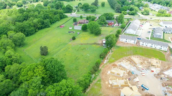an aerial view of a house with backyard space and lake view