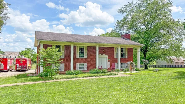a front view of house with yard and green space