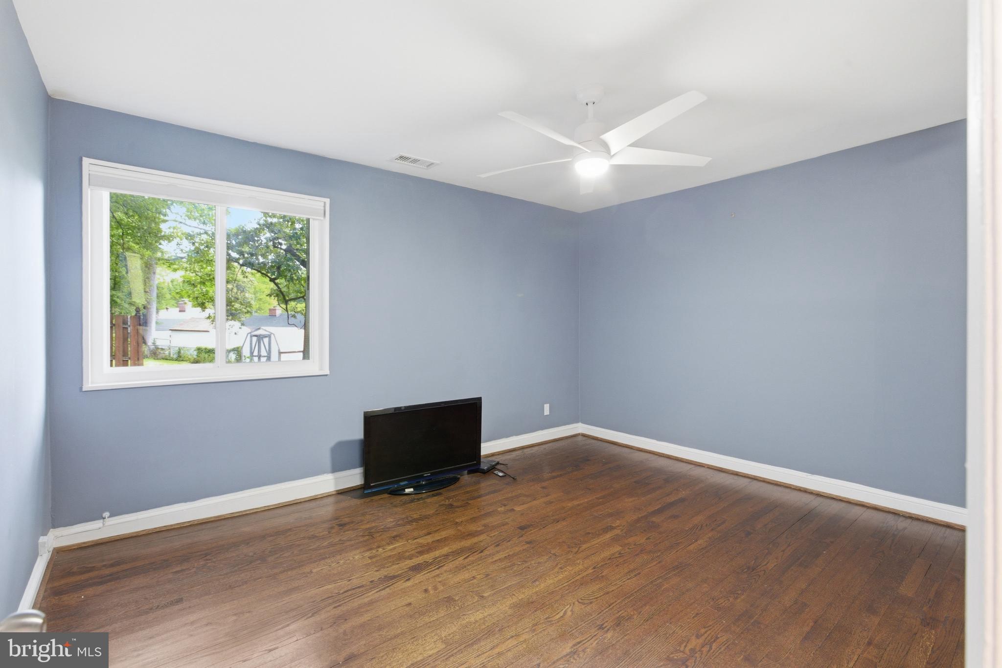 6801 Adelphi Road University Park, MD 20782 - Photo 16 of 26 Master bedroom has hardwood flooring & good light.