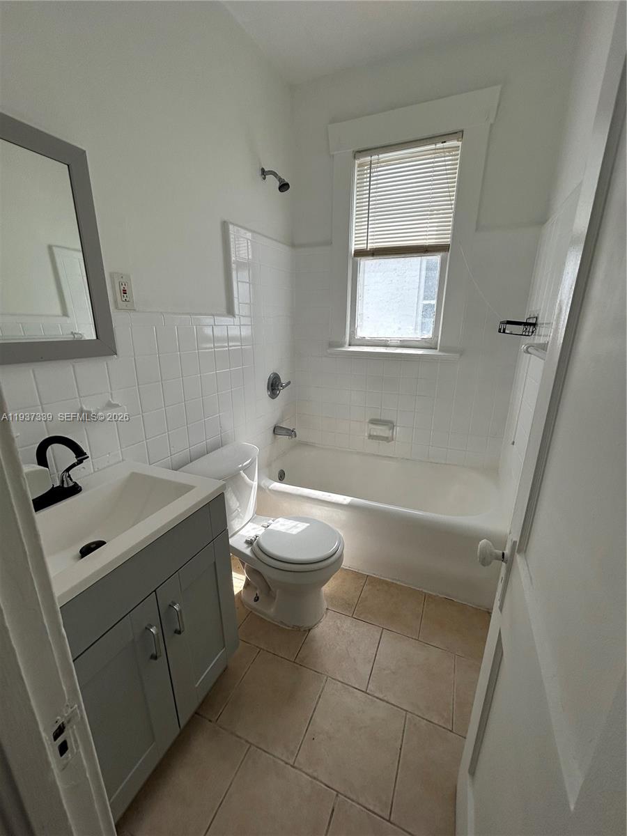 529 Northeast 66th Street, Unit 8 Miami, FL 33138 - Photo 5 of 5 a bathroom with a toilet sink and mirror