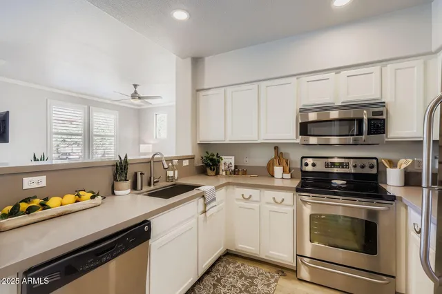 a kitchen with stainless steel appliances a refrigerator sink and cabinets