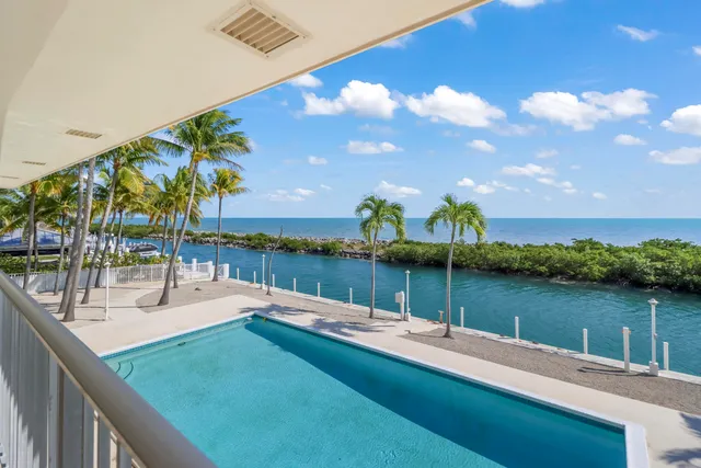 a view of a lake with couches and wooden floor
