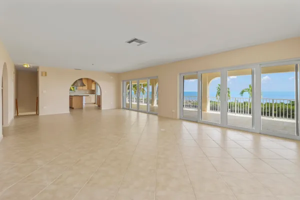 an empty room with floor to ceiling windows and pool