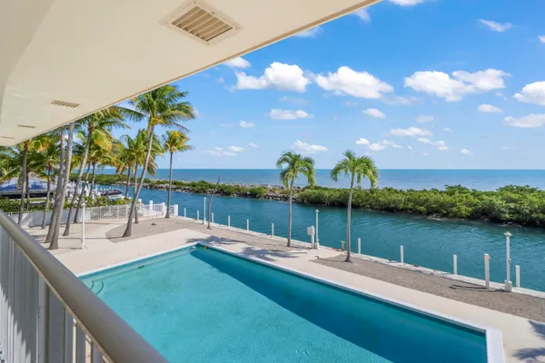 a view of a lake with couches and wooden floor