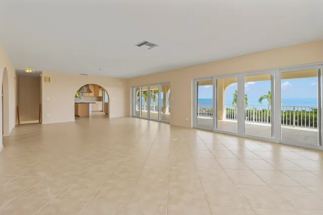 an empty room with floor to ceiling windows and pool