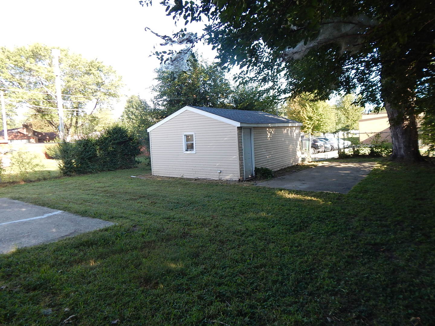 810 West 15th Street Sterling, IL 61081 - Photo 16 of 22 a house that is sitting in the grass with large trees