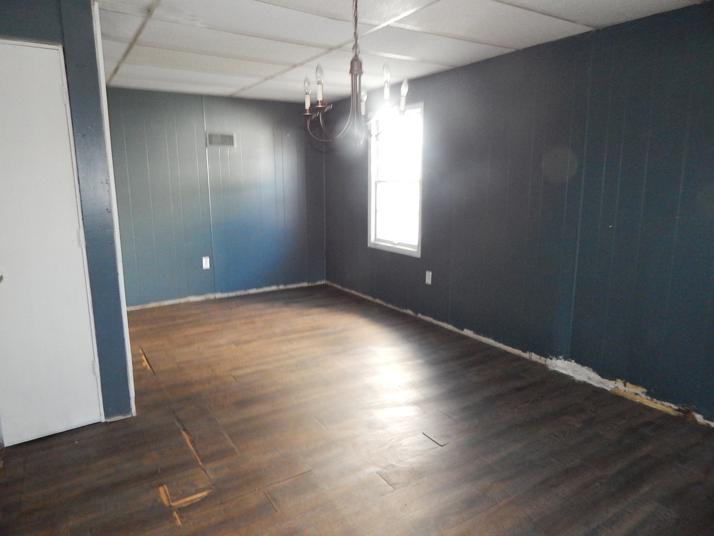 810 West 15th Street Sterling, IL 61081 - Photo 7 of 22 an empty room with wooden floor and windows