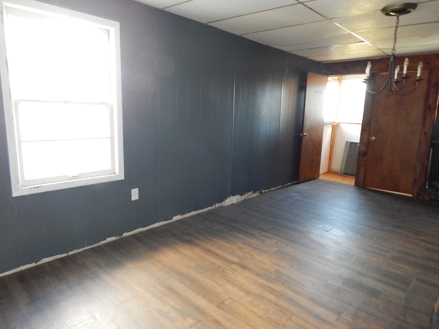 810 West 15th Street Sterling, IL 61081 - Photo 9 of 22 an empty room with wooden floor and windows
