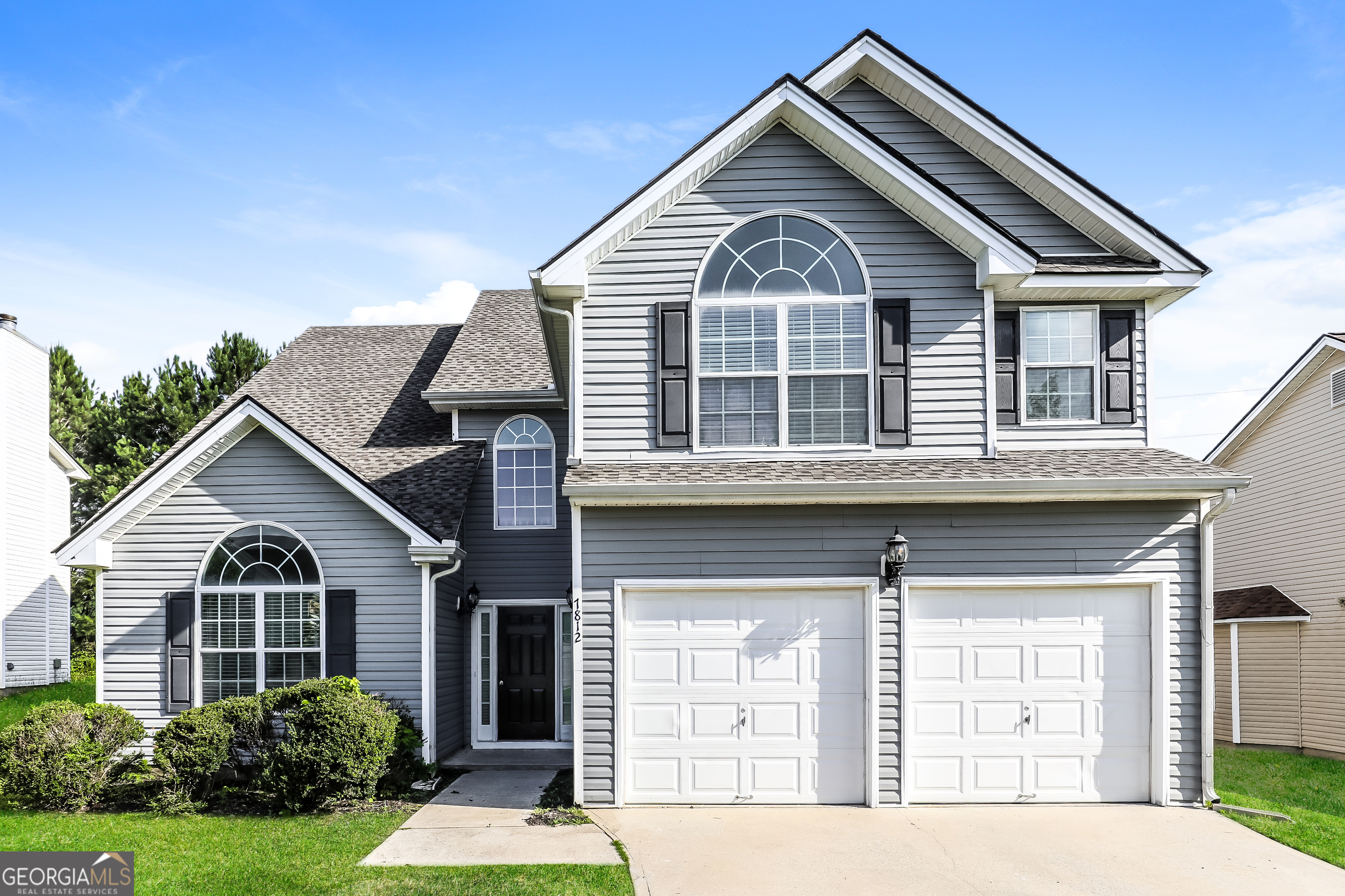 a front view of a house with a yard
